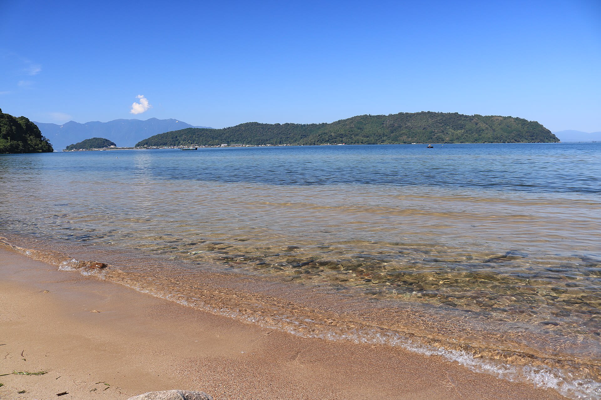 Okishima island seen across the water of Lake Biwa from the mainland shore