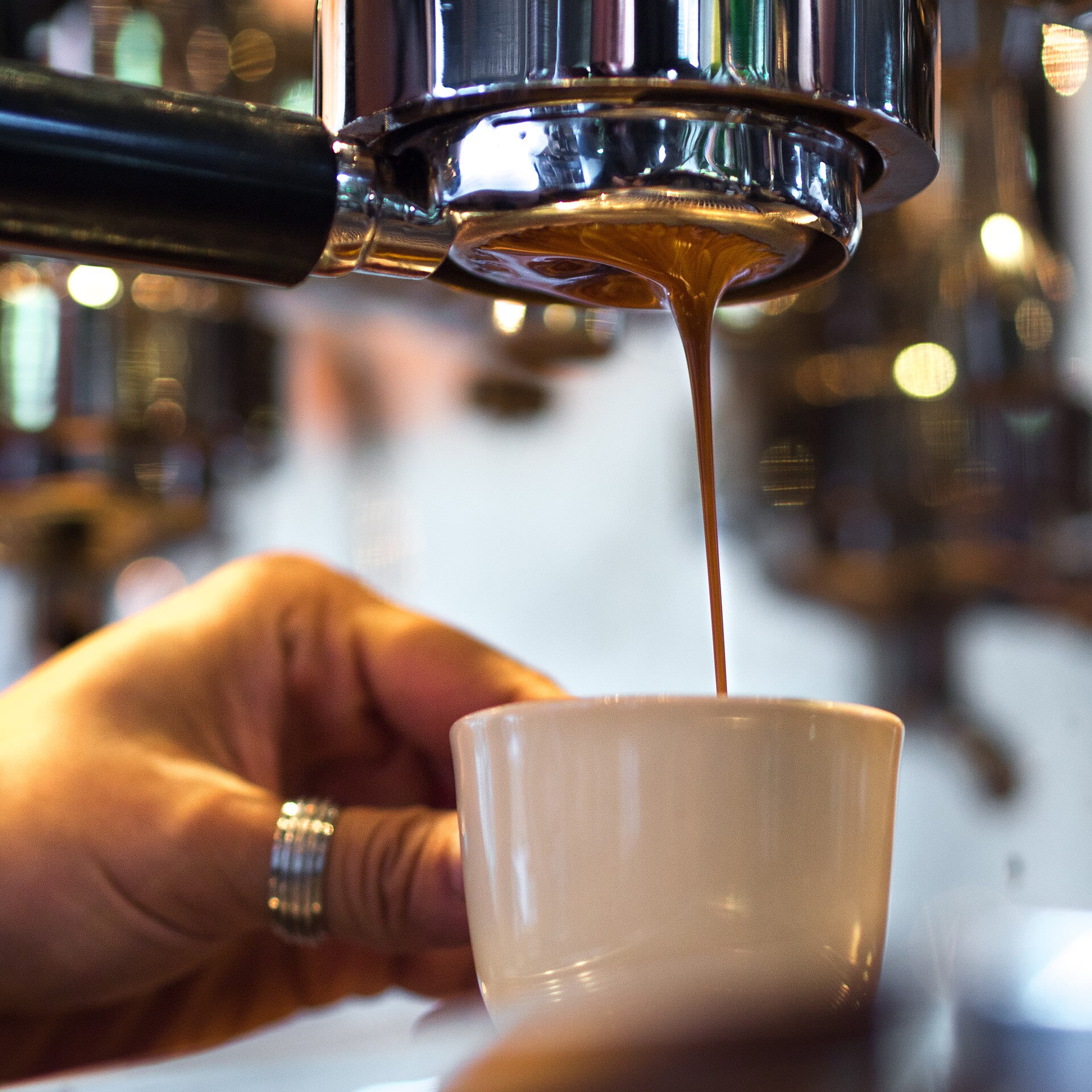 Barista pulling an espresso shot on a naked portafilter at Akha Ama in Chiang Mai