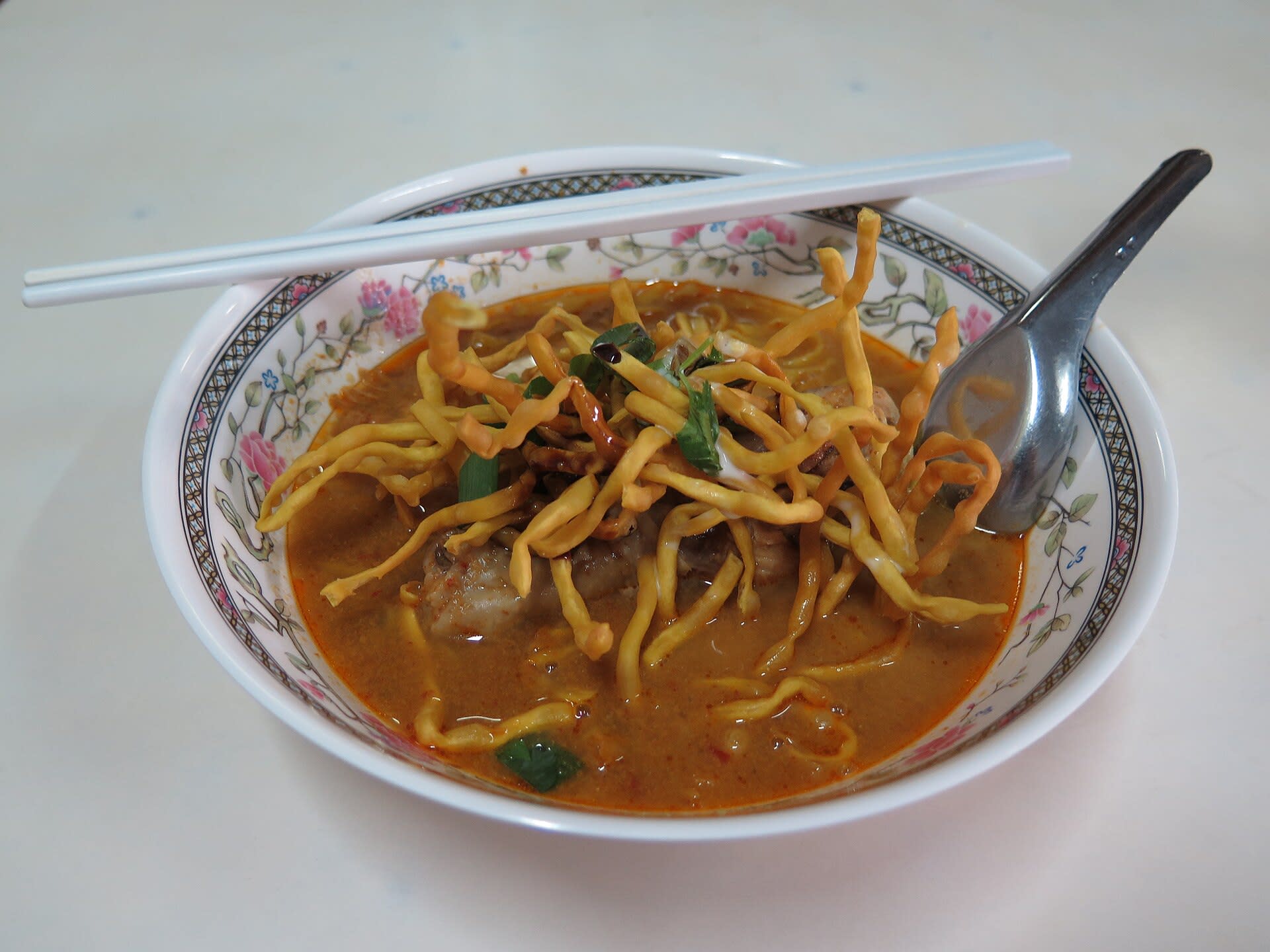 Bowl of khao soi, northern Thai coconut curry noodle soup