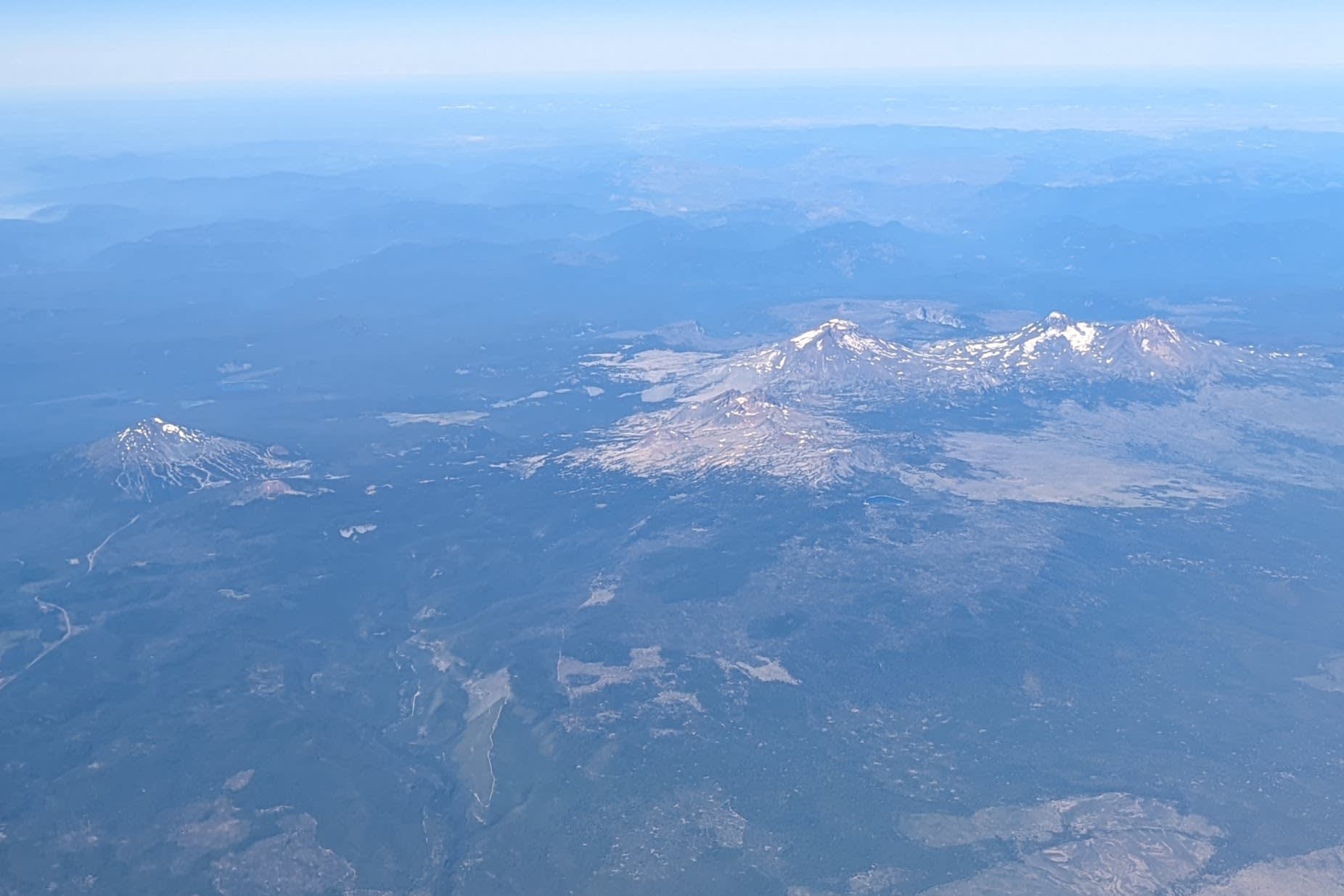 The Three Sisters and Mount Bachelor rising behind high-desert landscape near Bend