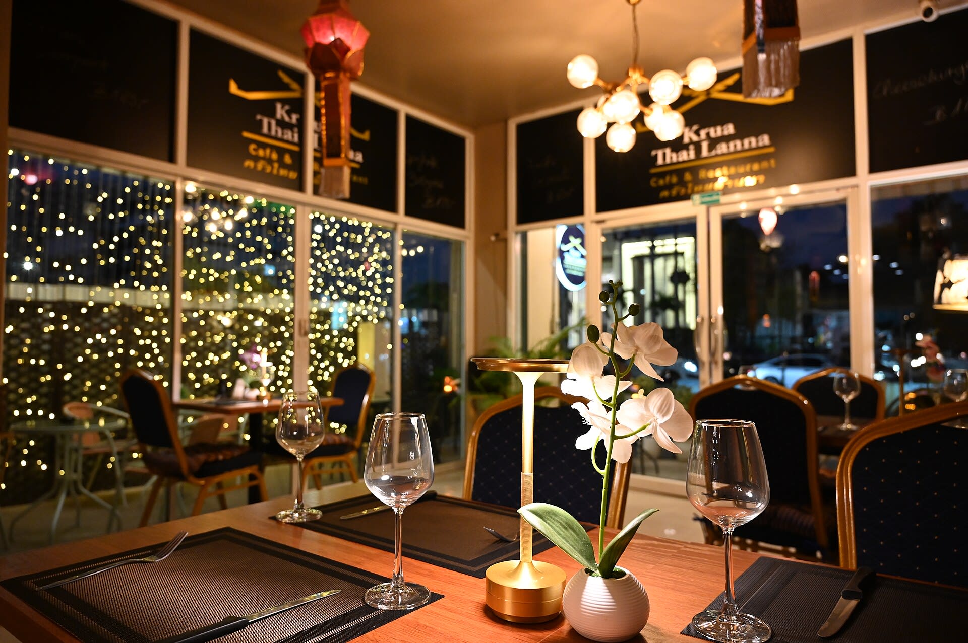 Candlelit dinner table set with wine glasses at a restaurant
