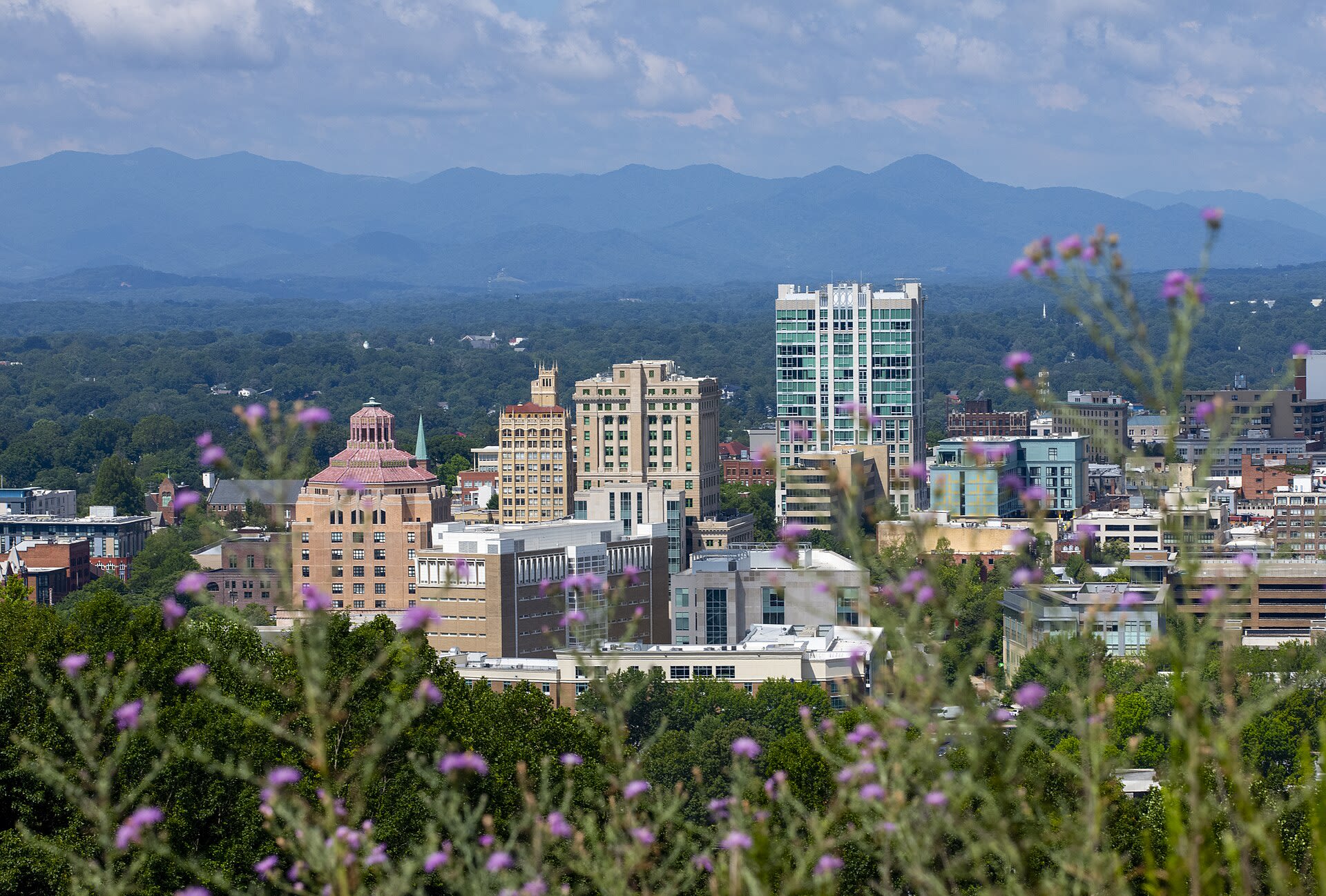 Downtown Asheville skyline with Beaux-Arts and Art Deco buildings set against the Blue Ridge Mountains