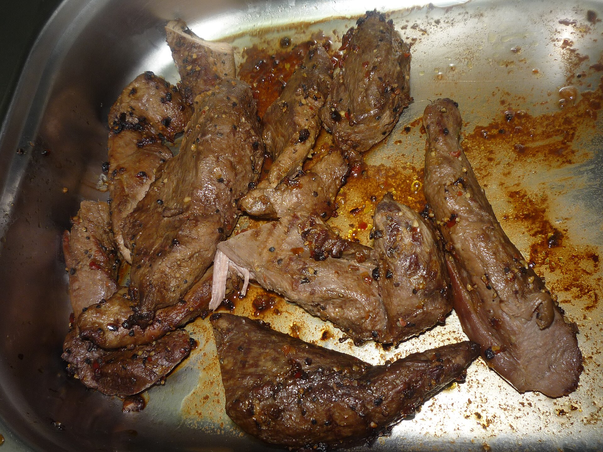 Czech dish of venison svíčková with green pepper sauce on a plate