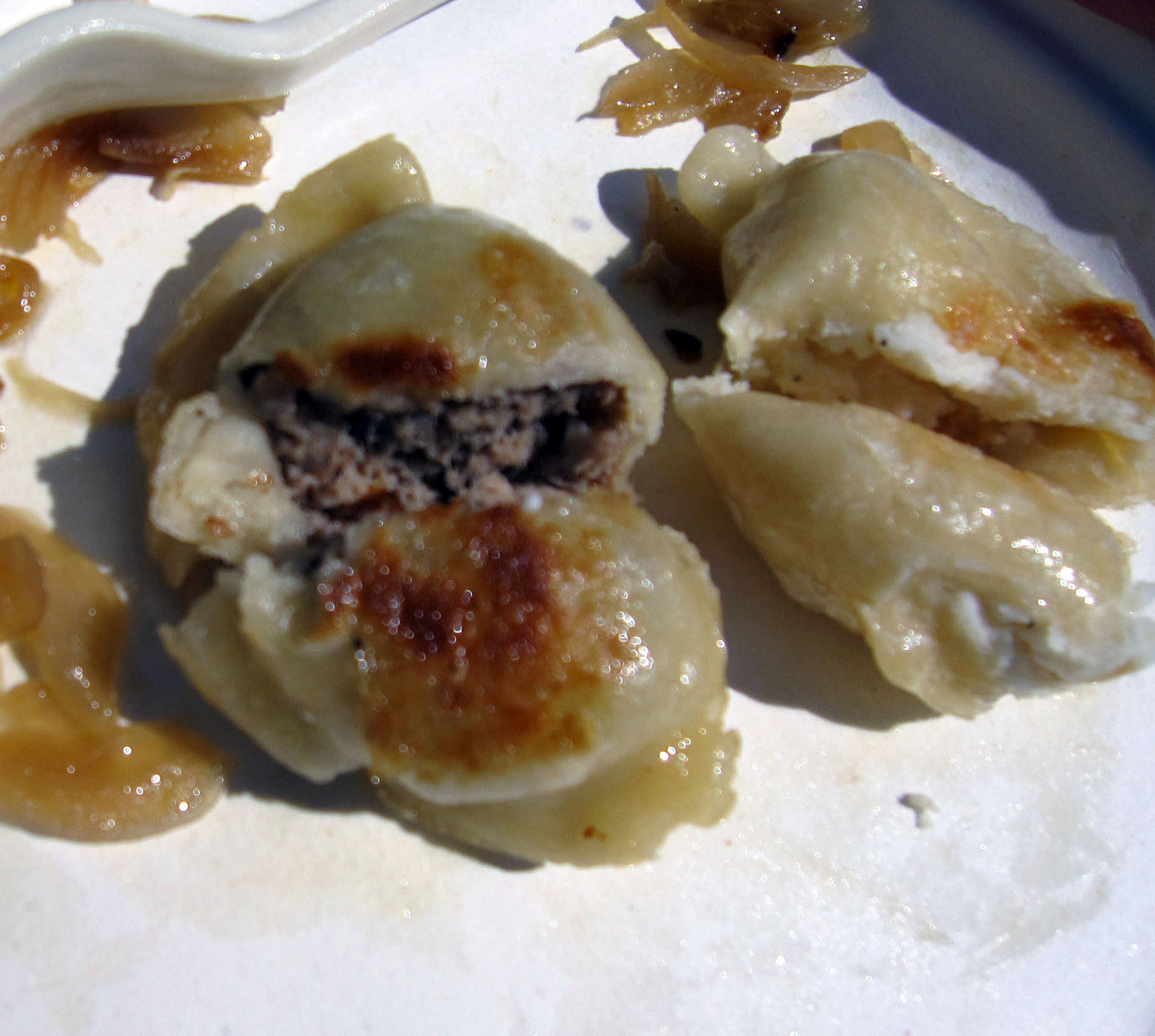 Plate of traditional Polish pierogi dumplings with meat and potato filling