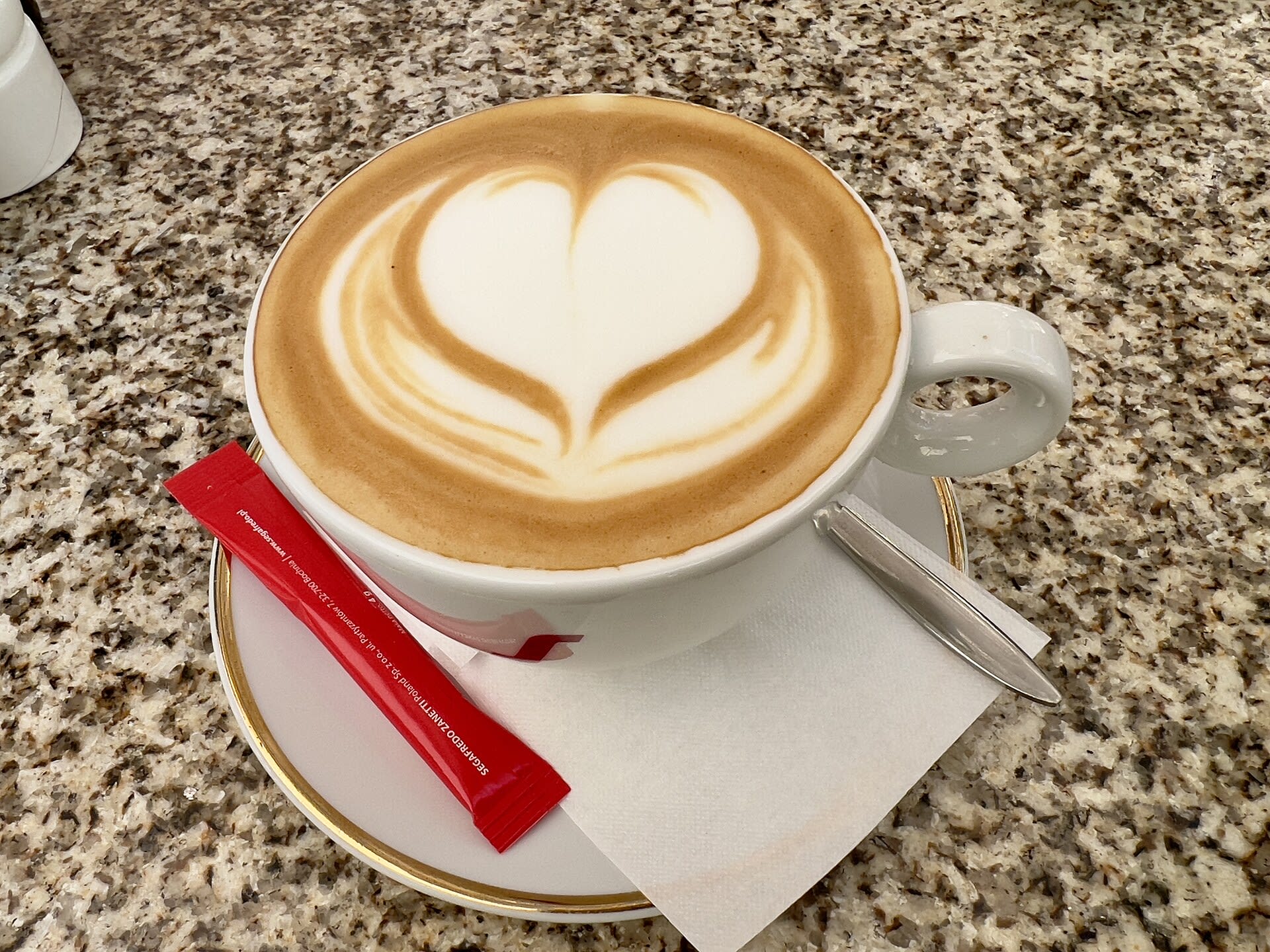 Cappuccino cup with heart-shaped latte art in a Krakow cafe