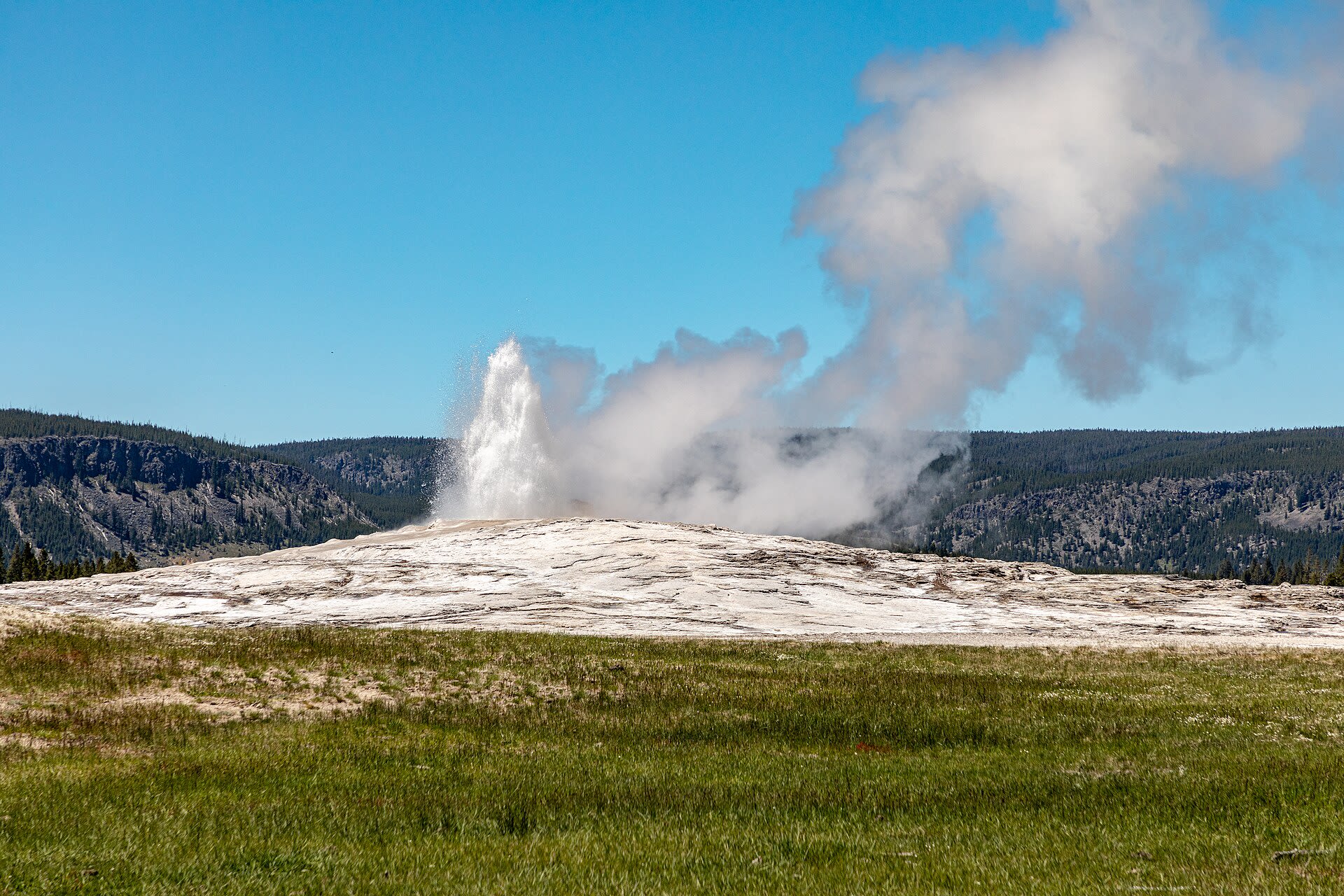 Old Faithful geyser erupting in Yellowstone National Park