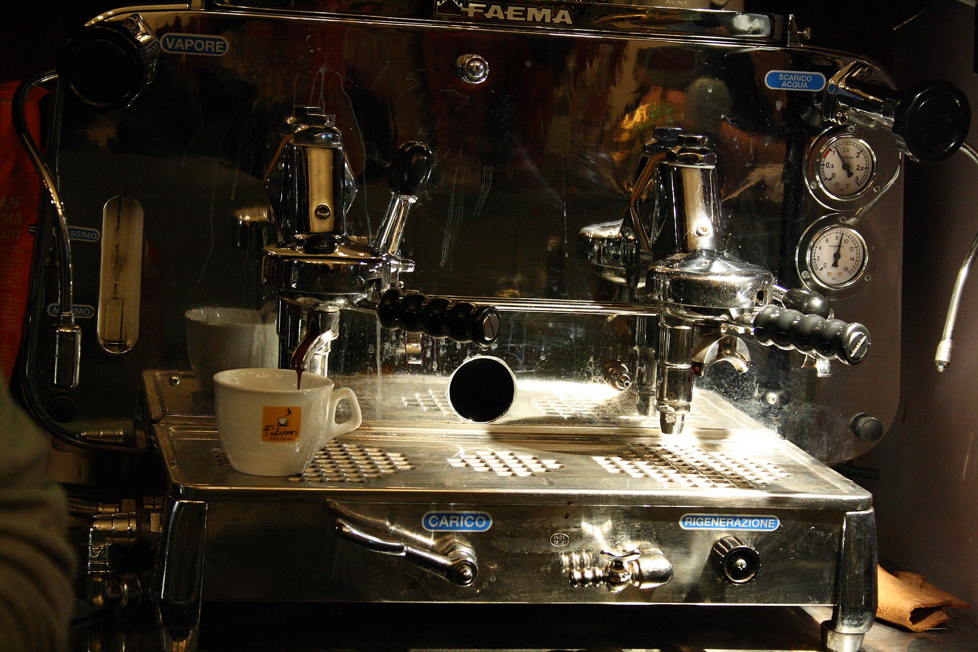 Barista making espresso on a Faema machine in a Brno cafe