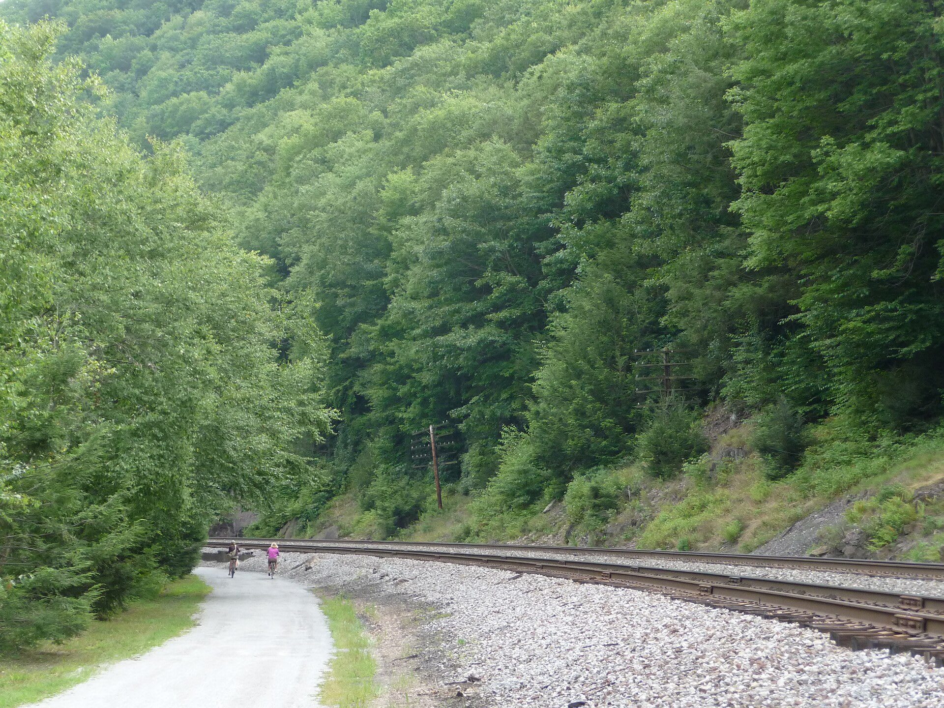 Cyclists riding the crushed-stone Lehigh Gorge Trail alongside the old rail line