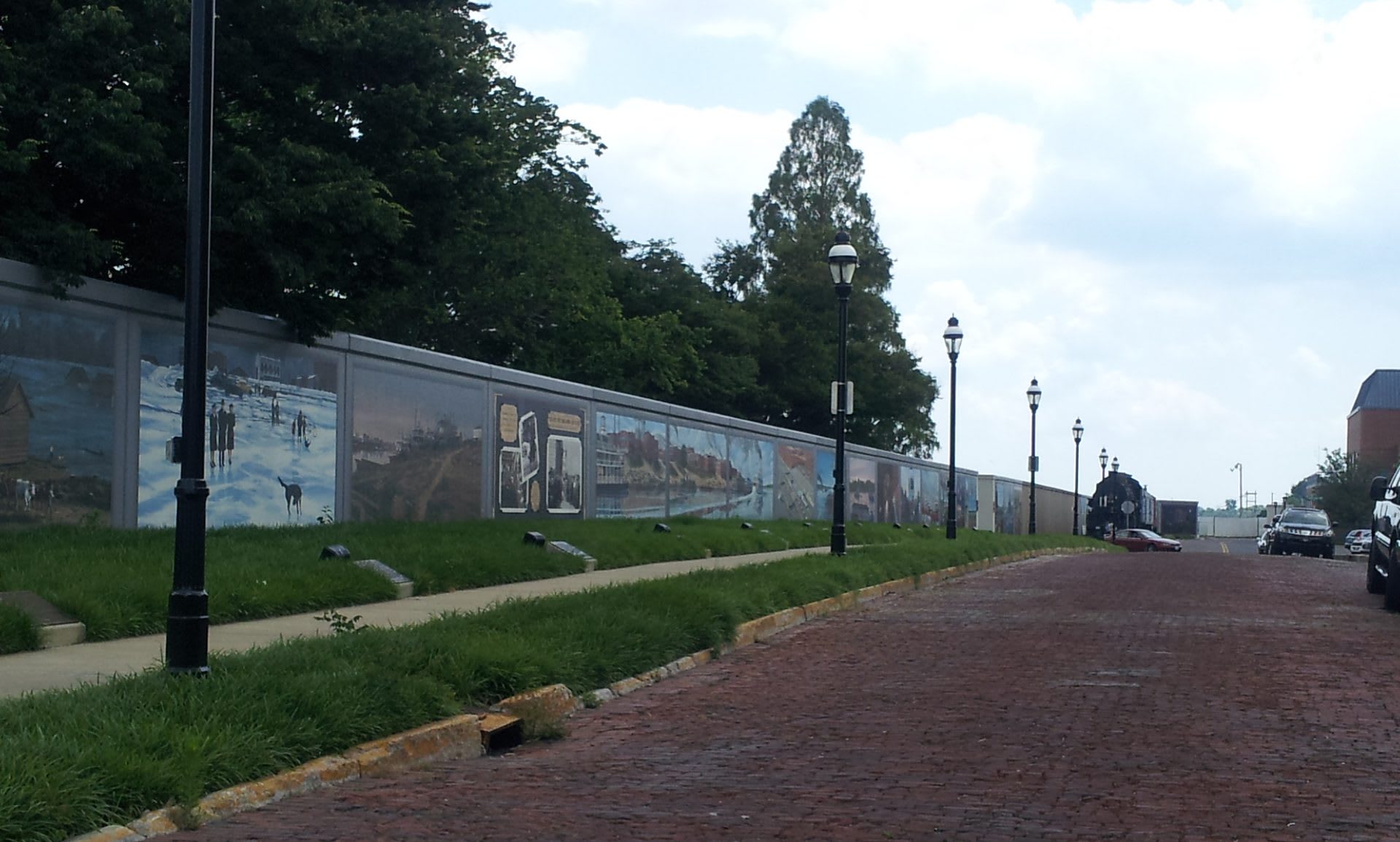 Stretch of Paducah's floodwall covered with historical murals along the riverfront walk