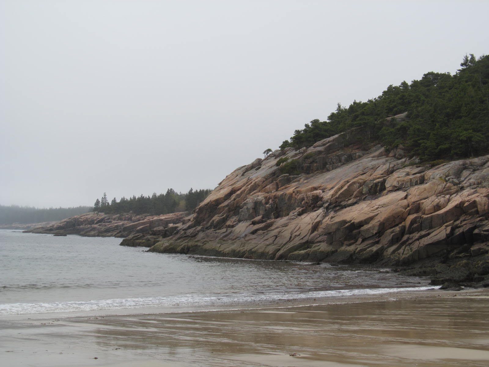 Sand Beach in Acadia National Park, framed by pink granite cliffs along the shoreline