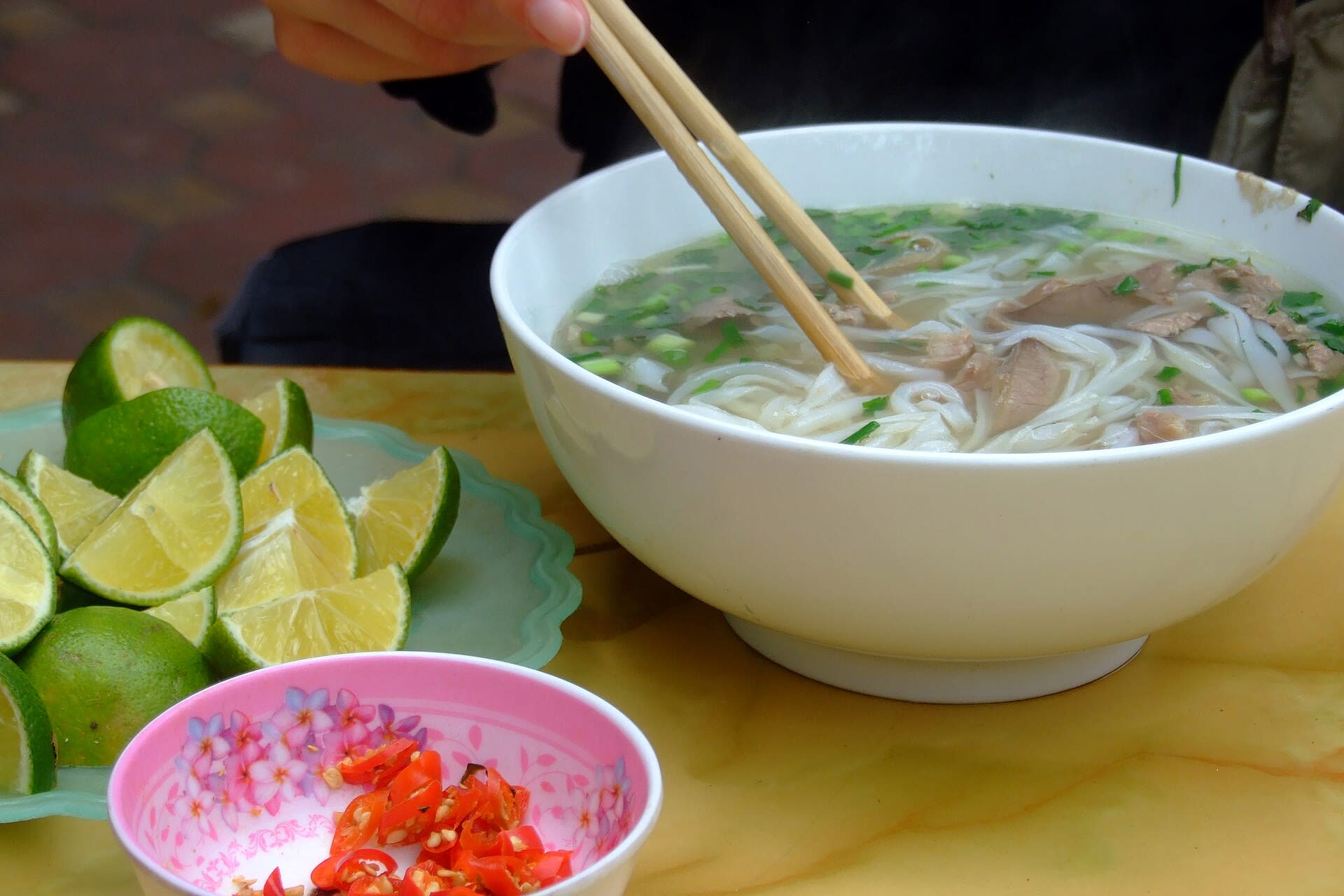 Bowl of pho bo beef noodle soup served at a Hanoi eatery