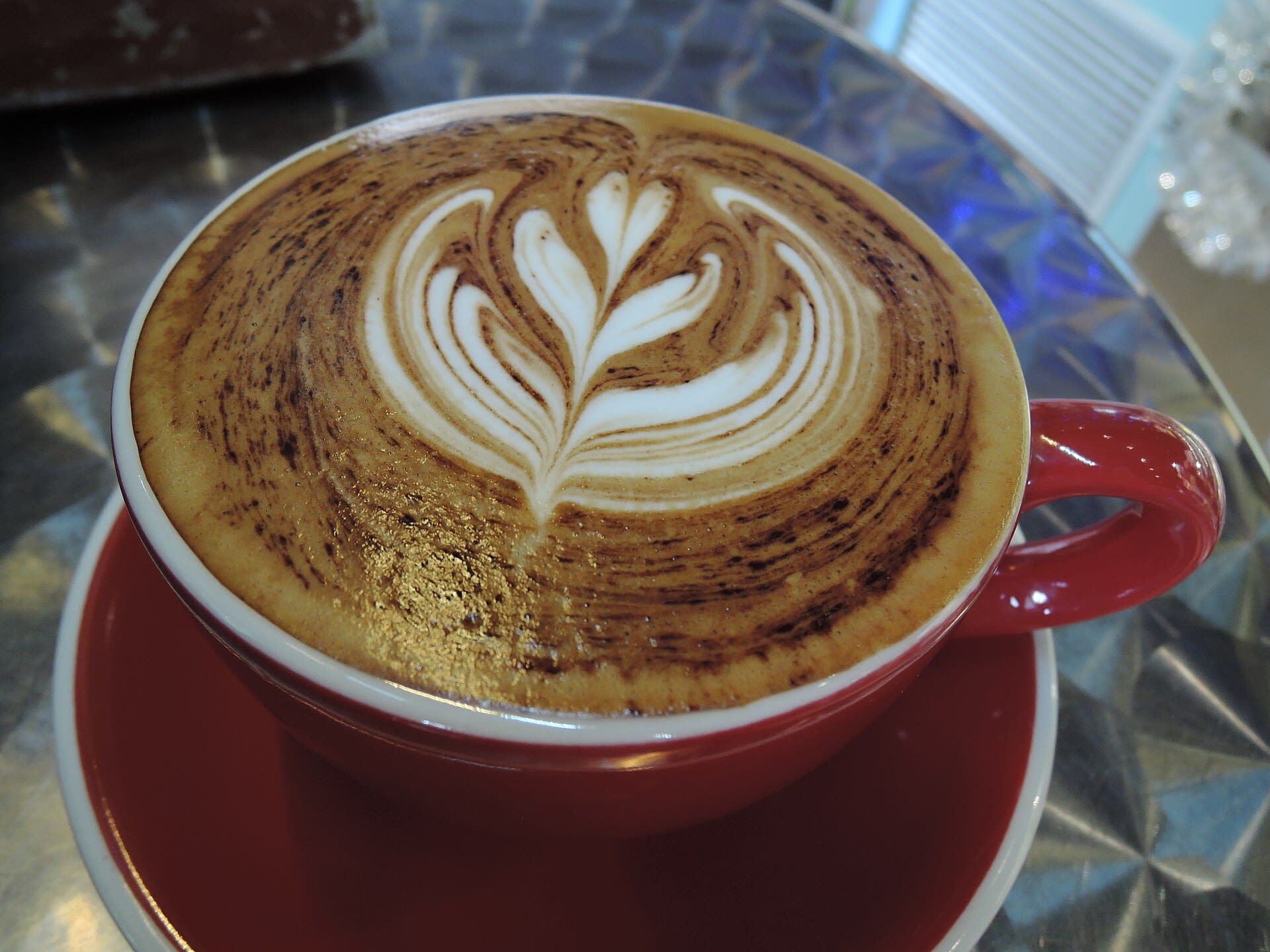 Cappuccino topped with latte art in a coffee cup