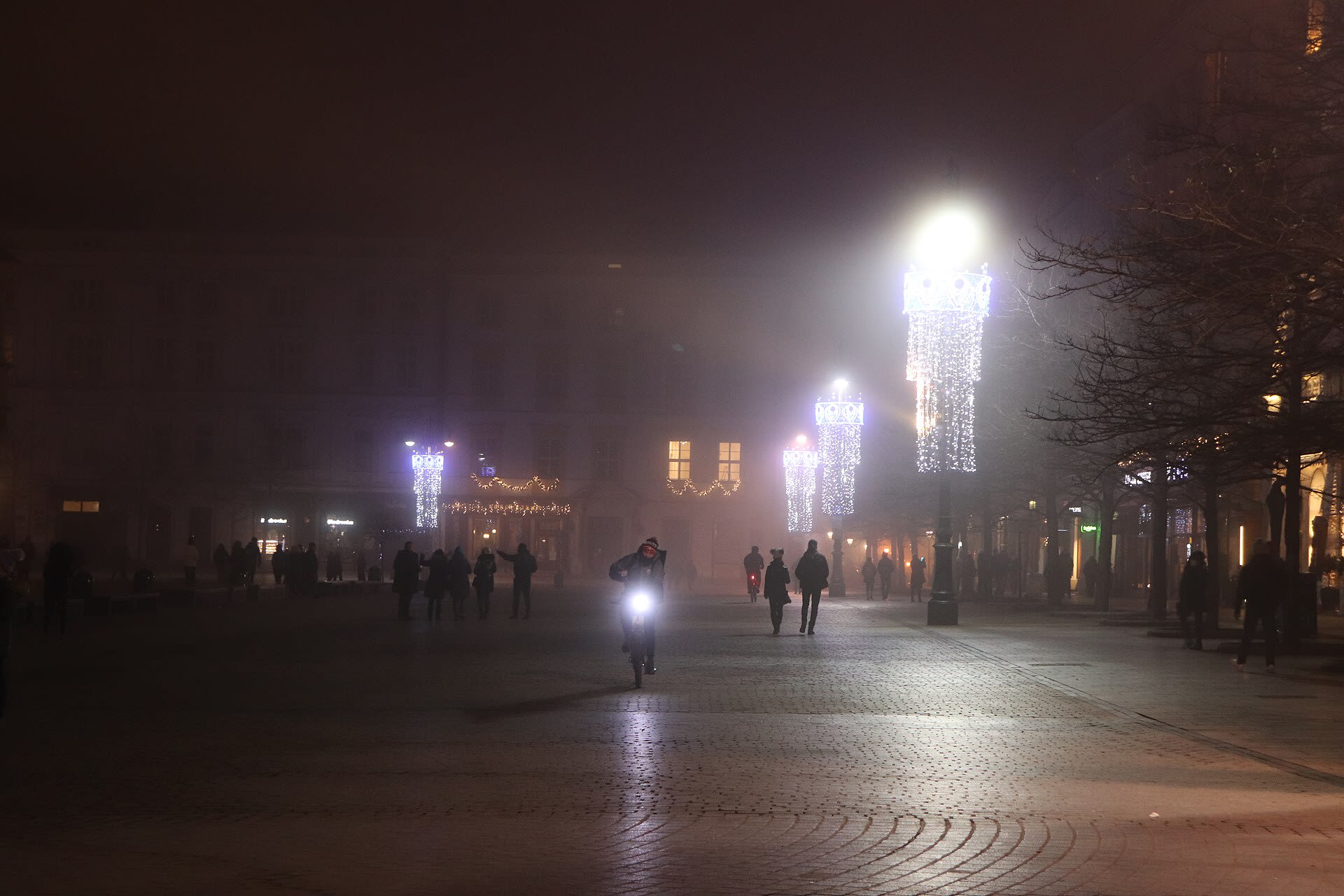 Krakow Main Market Square illuminated at night with the Cloth Hall and St Mary's Basilica