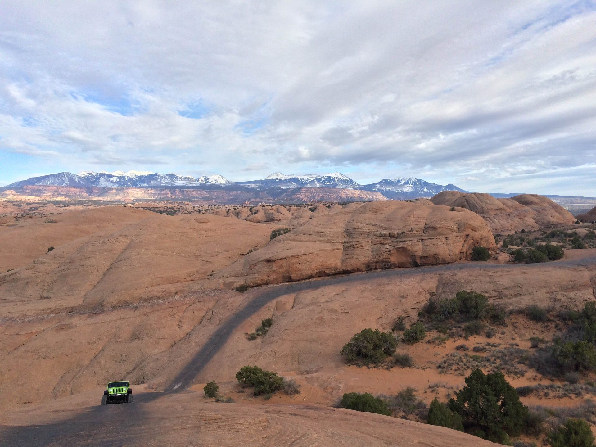A Jeep descending the slickrock on Hell's Revenge Trail during Moab's Easter Jeep Safari