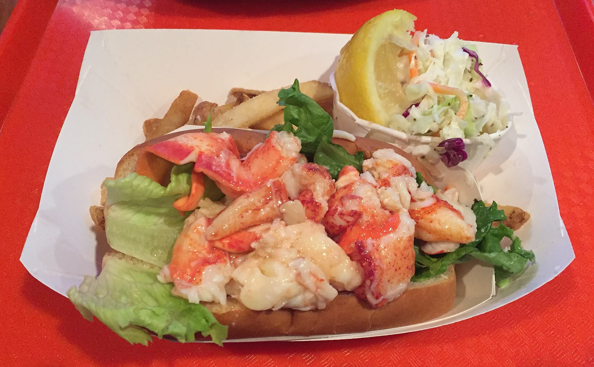 Lobster roll sandwich served with fries
