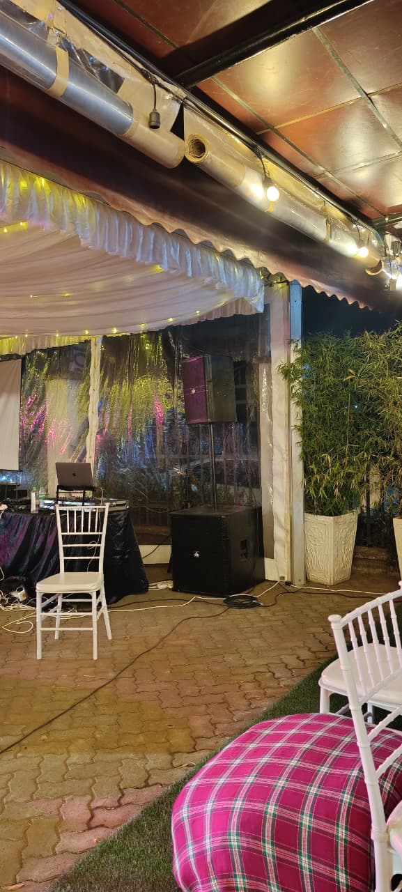 Speaker and subwoofer setup in a courtyard