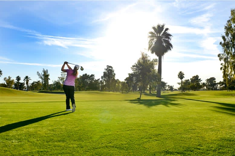 Woman golfer swinging the club