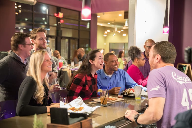 Group of people eating and laughing at Canyon 49