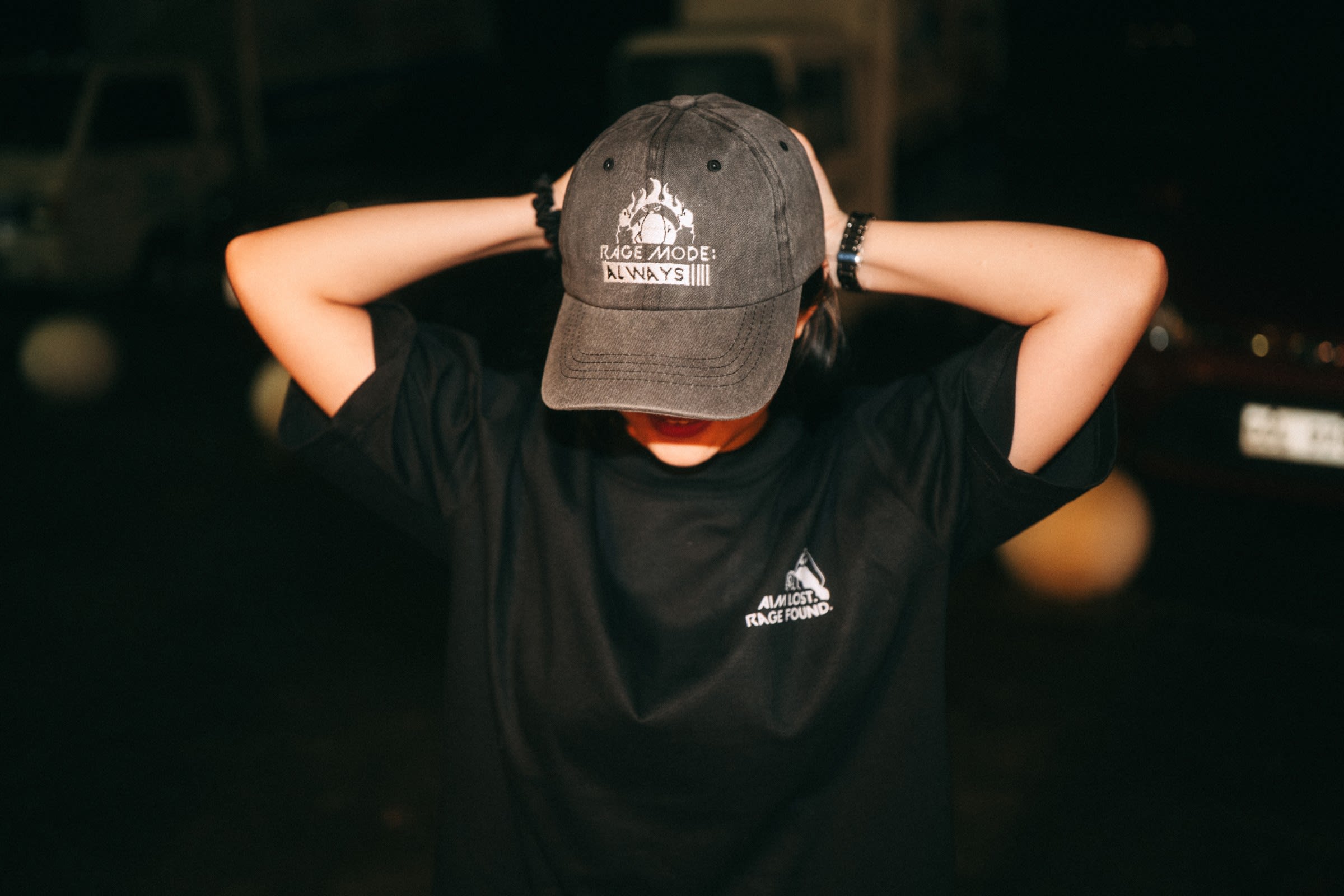 Model wearing Rage Mode: Always Cap and AIM LOST. RAGE FOUND. Tee