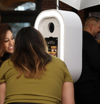 Wedding guests enjoying an open-air photo booth