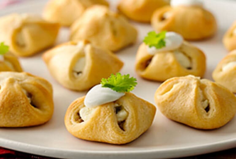 Prepping the cream cheese and sausage filling in Pillsbury Crescent dough  sheets - The Southerly Magnolia