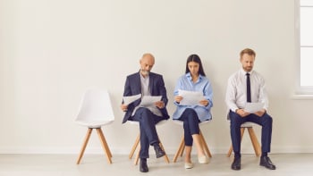 Four adults sitting in a row preparing for job interviews, representing Generation Australia’s employment programs