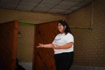 Illustration showing a woman breaking through a symbolic glass ceiling, representing leadership, progress, and economic mobility.