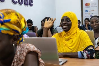 Student in yellow headscarf raises her hand in class