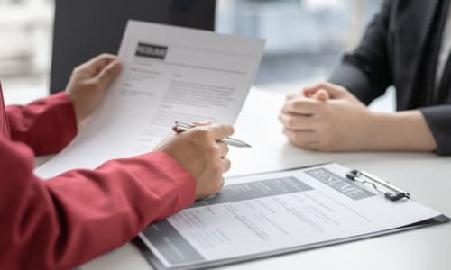 Recruiter reviewing a resume with a job candidate during an interview