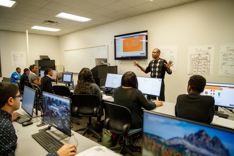 Learners in a classroom listening to an instructor