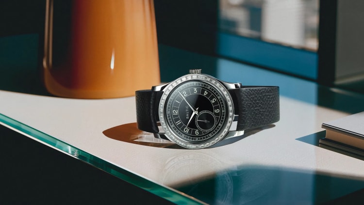 A collection of Baltic Watches displayed on a wooden surface, showcasing different vintage-inspired designs.