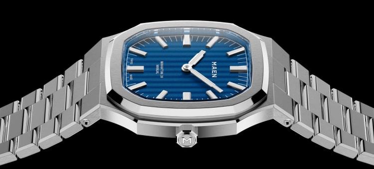 A sleek Maen Hudson watch with a blue dial and stainless steel bracelet.