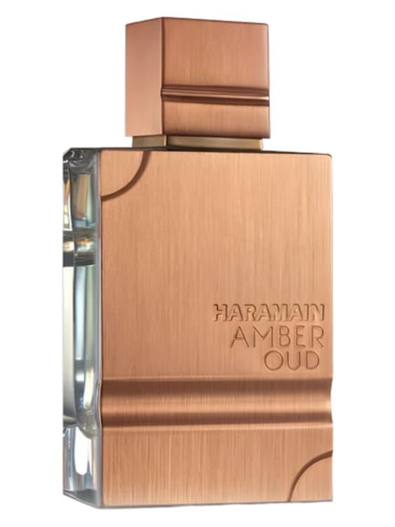 A bottle of Al Haramain Amber Oud with golden detailing set against a textured background.