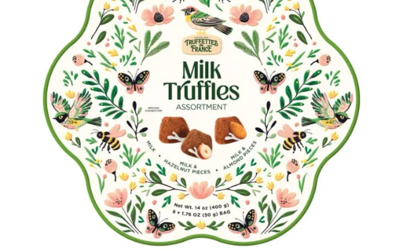 Milk truffles assortment packaging floral and butterfly design surrounding text and image of chocolates in the center