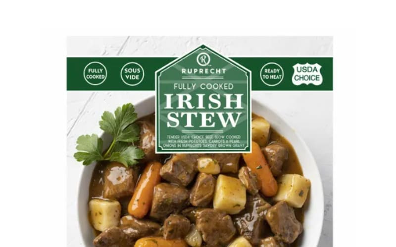 Bowl of Irish stew with meat carrots and potatoes under packaging label