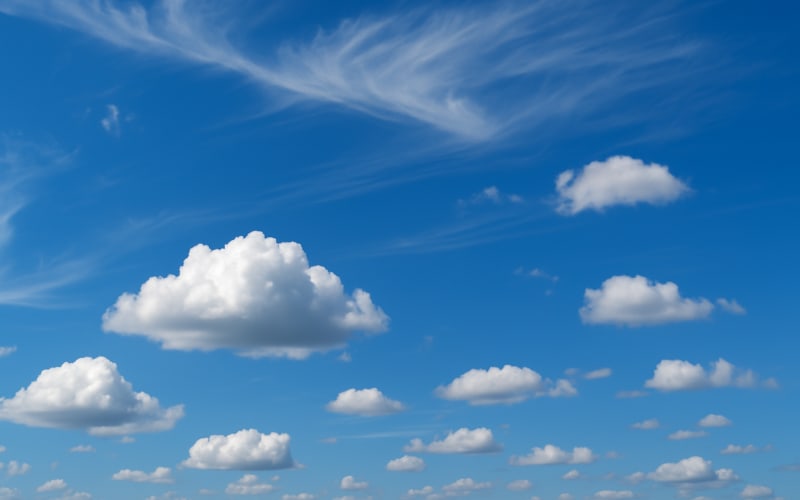 A variety of cloud shapes, from fluffy cumulus to thin cirrus clouds, against a blue sky.