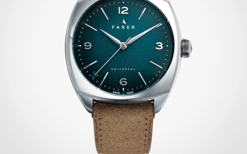 Silver Farer wristwatch with a textured teal dial and brown suede strap.