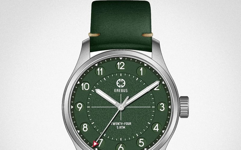 Green dial wristwatch with silver case, white numerals, and green leather strap.