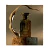 Flacon de parfum, Anfas (Ghala Extrait), verre ambré avec bouchon doré, design orné, taille non visible, accent de feuille séchée