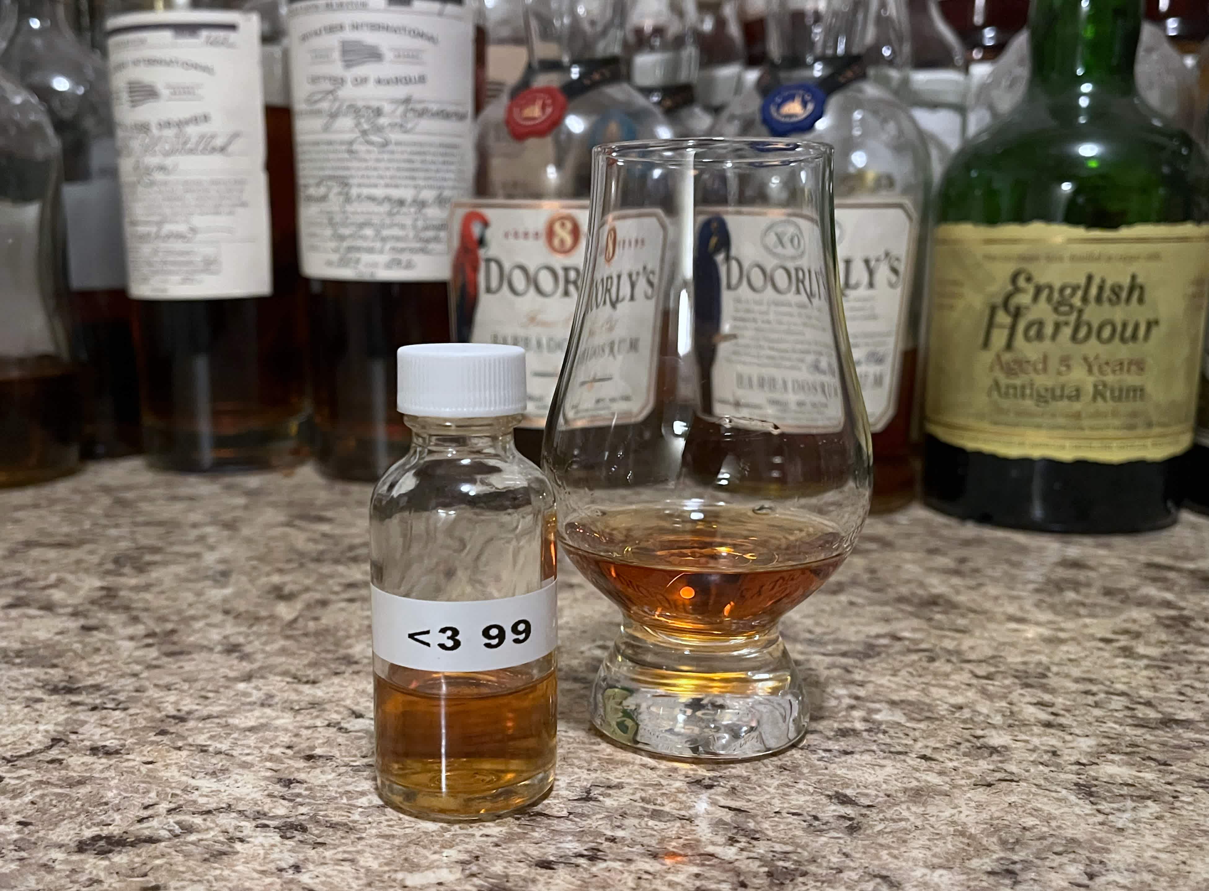 Sample bottle of Appleton Hearts 1999 on a counter next to a glencairn with rum poured in it