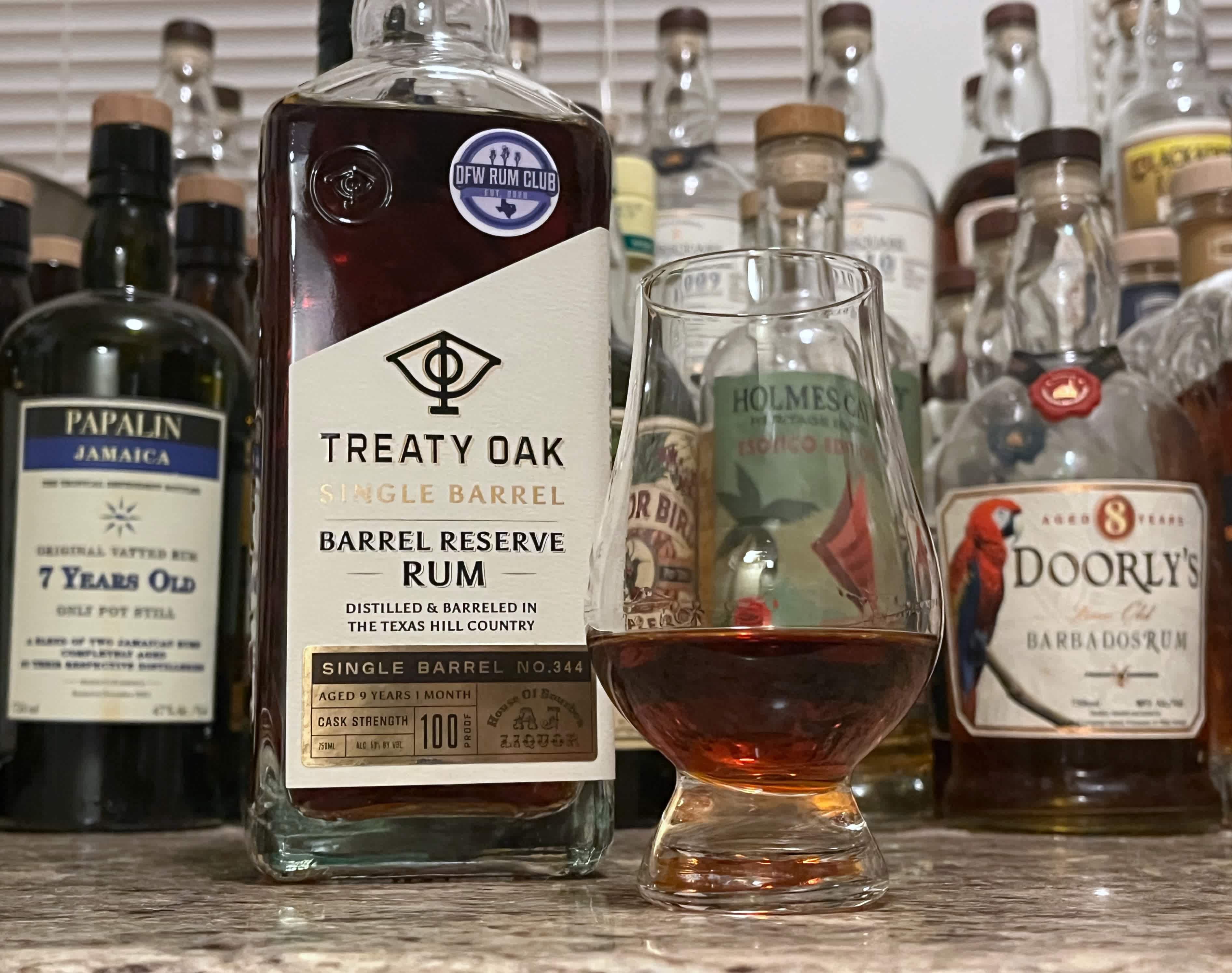 A bottle of Treaty Oak Single Barrel No. 334 next to a glencairn of rum