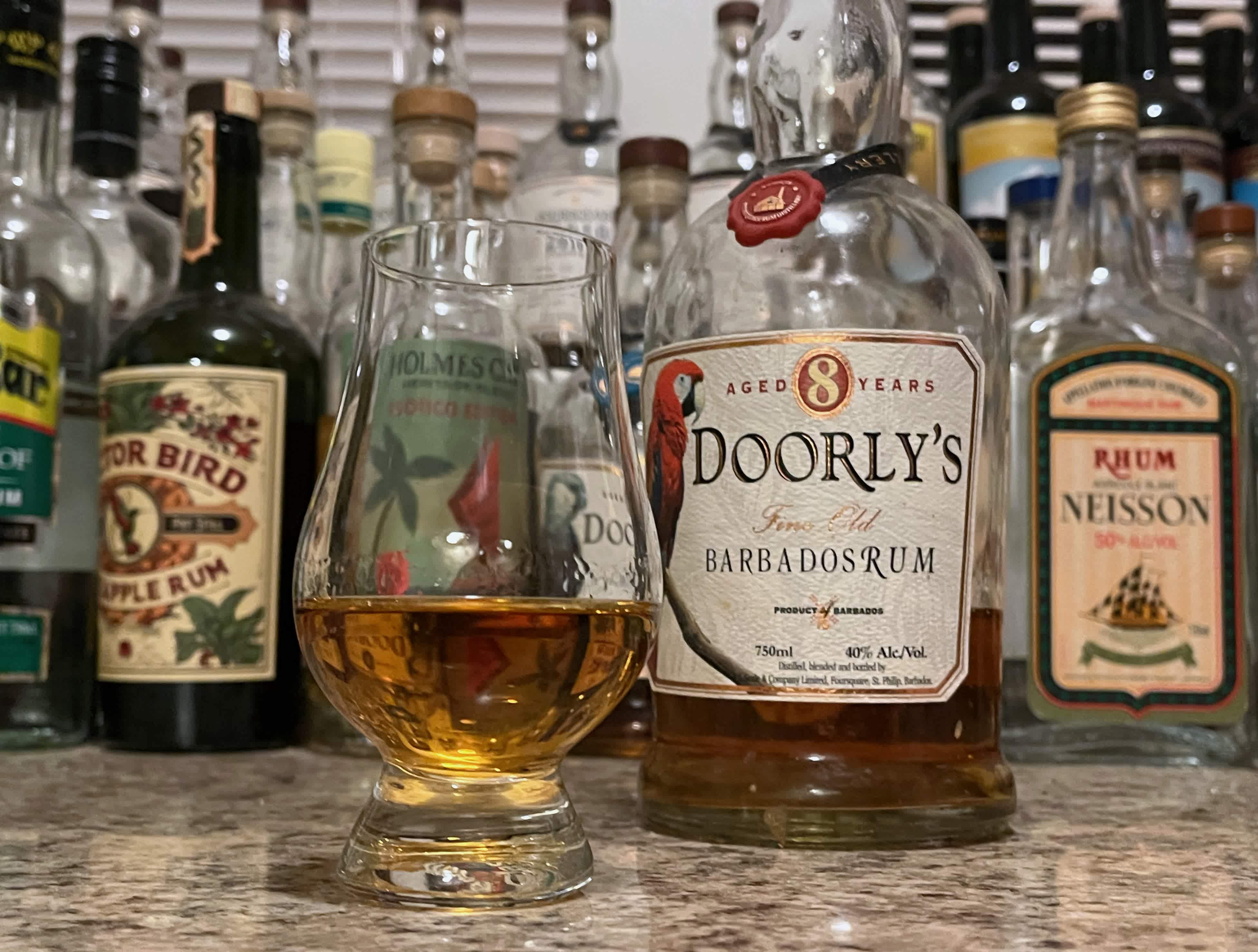 A bottle of Doorly's XO next to a glencairn of rum