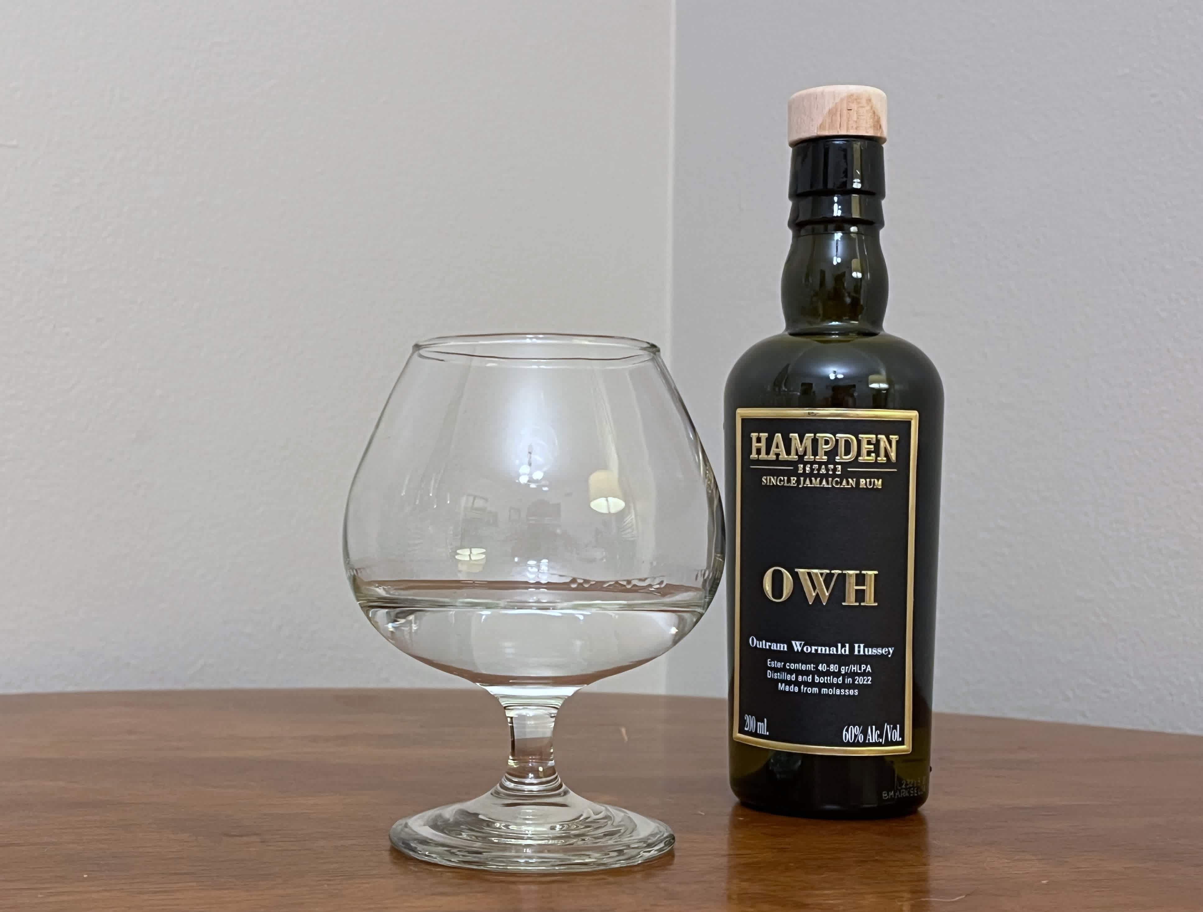 A bottle of Hampden 8 Marks OWH next to a glass of rum