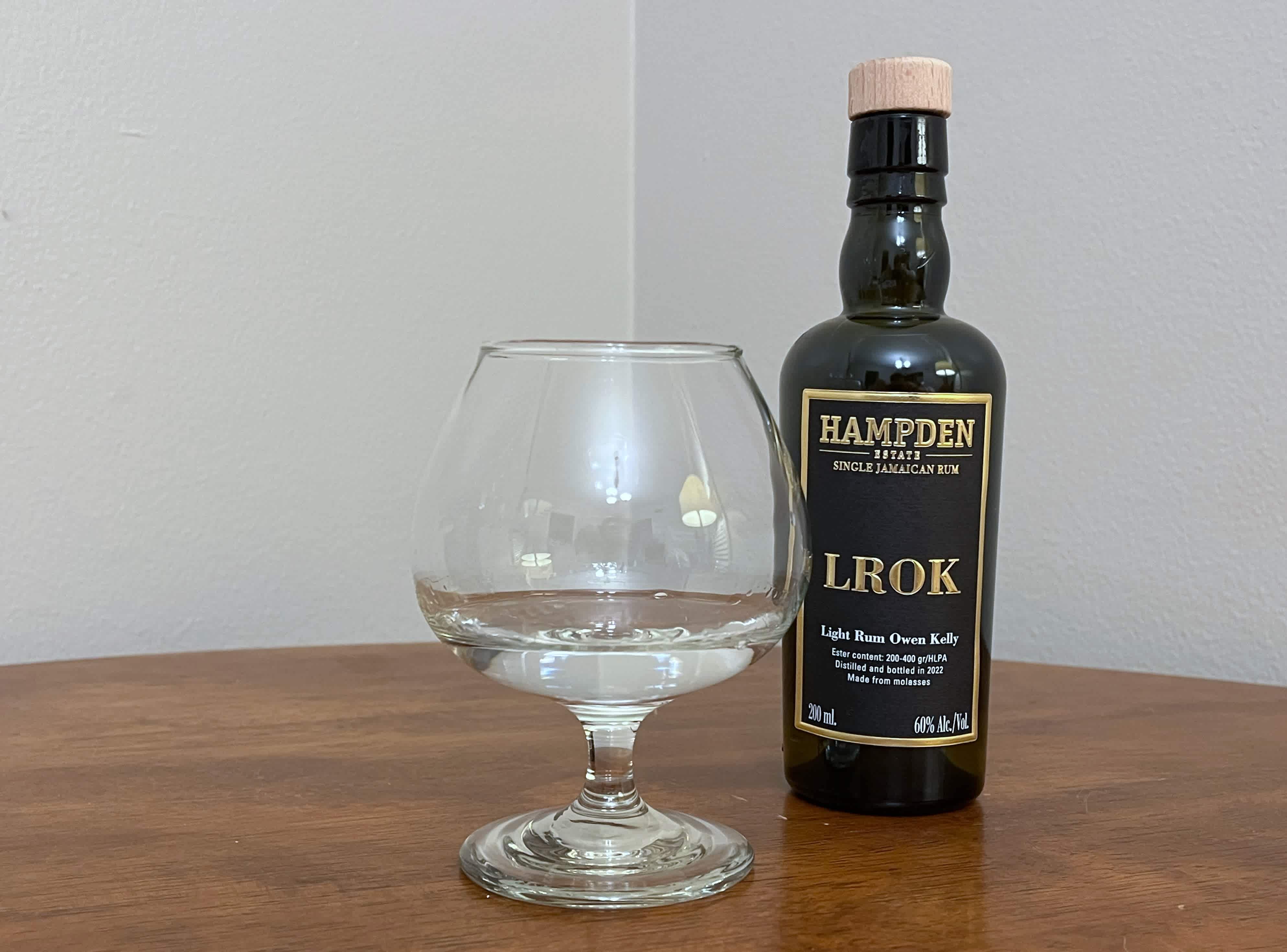 A bottle of Hampden 8 Marks LROK next to a glass of rum
