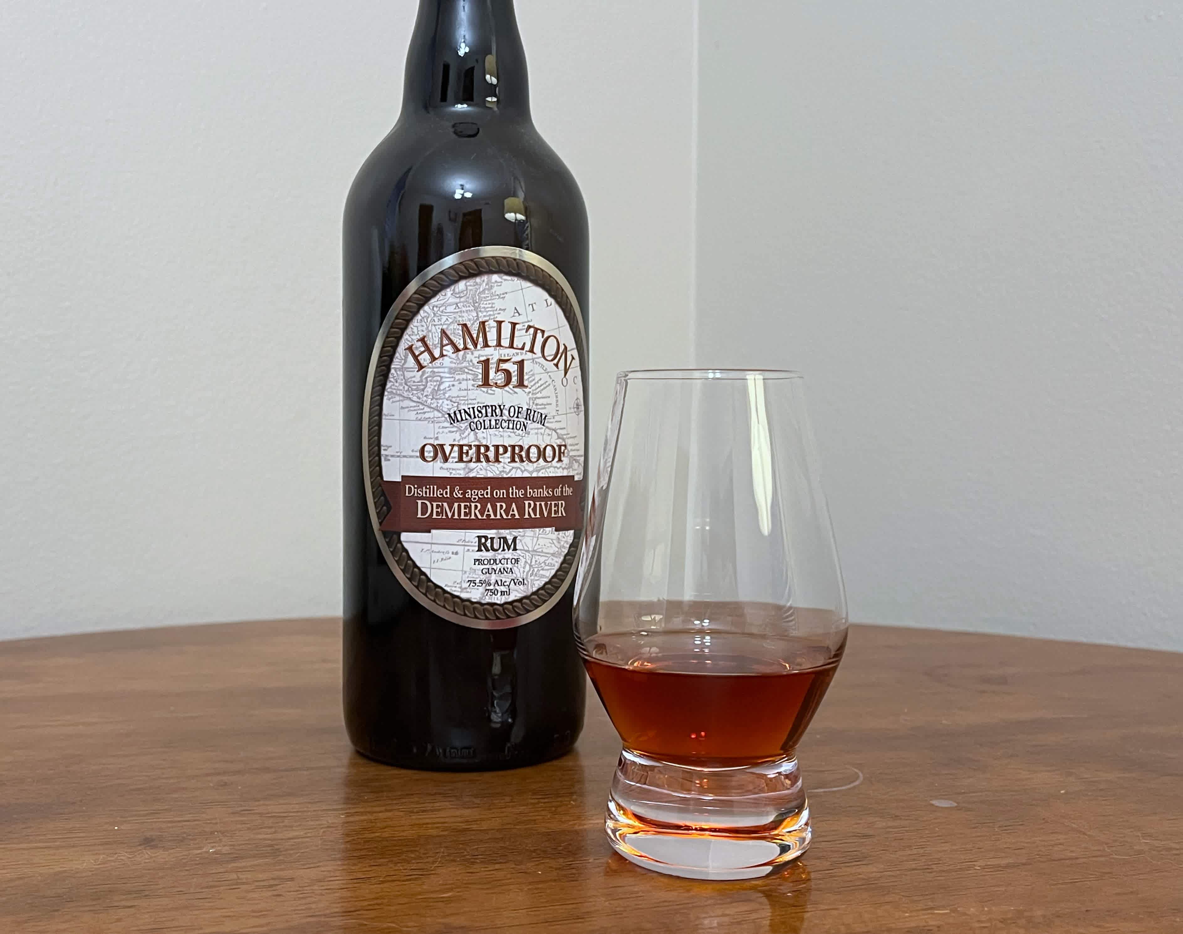 Bottle of Hamilton 151 next to a glass of rum