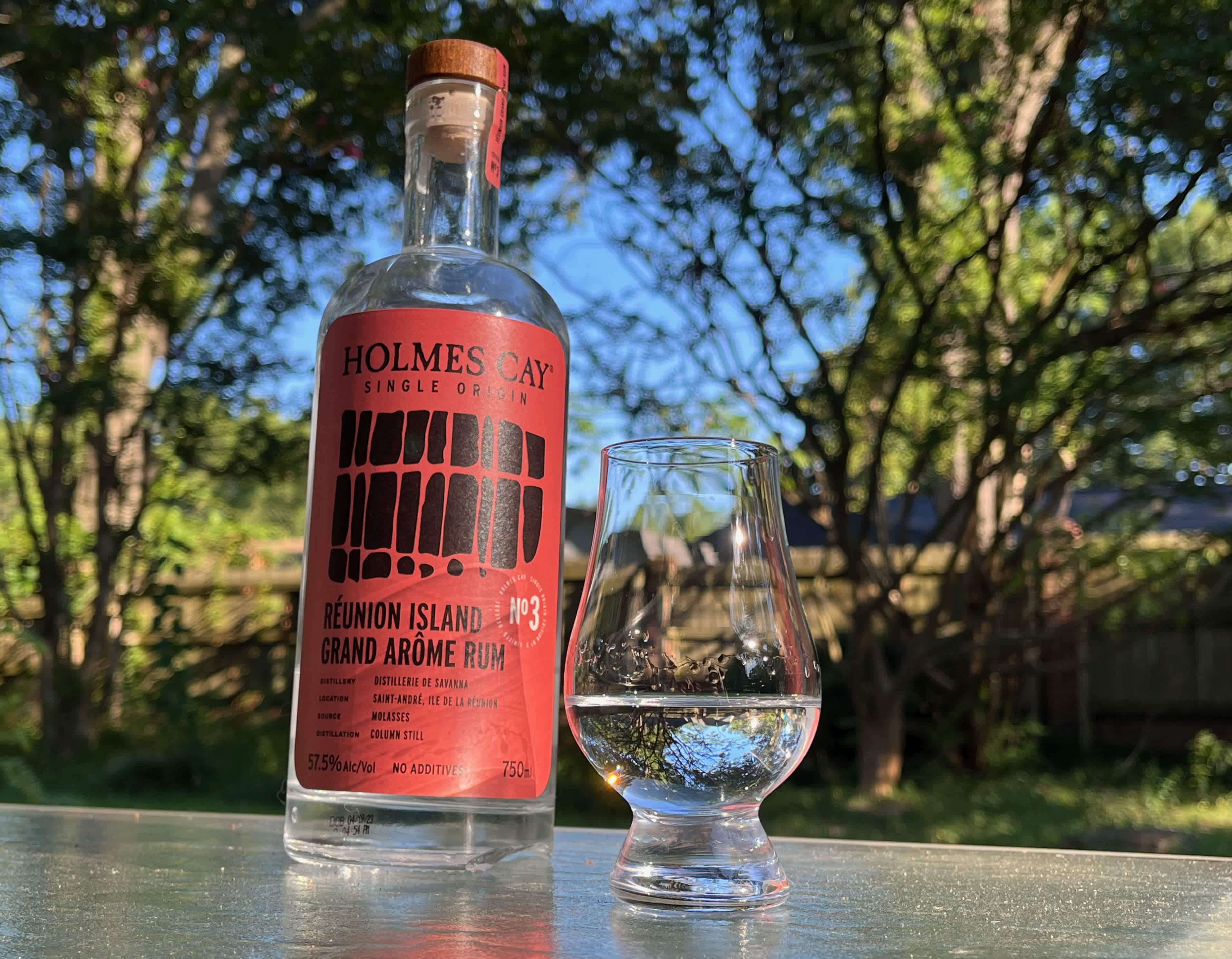 A bottle of Holmes Cay Réunion Island Grande Arôme next to a glass of rum