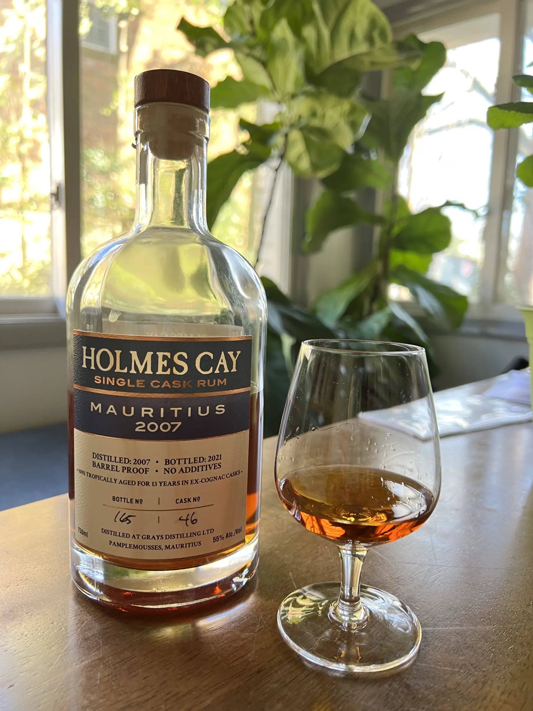 Holmes Cay Mauritius bottle sitting on a table next to a tasting glass