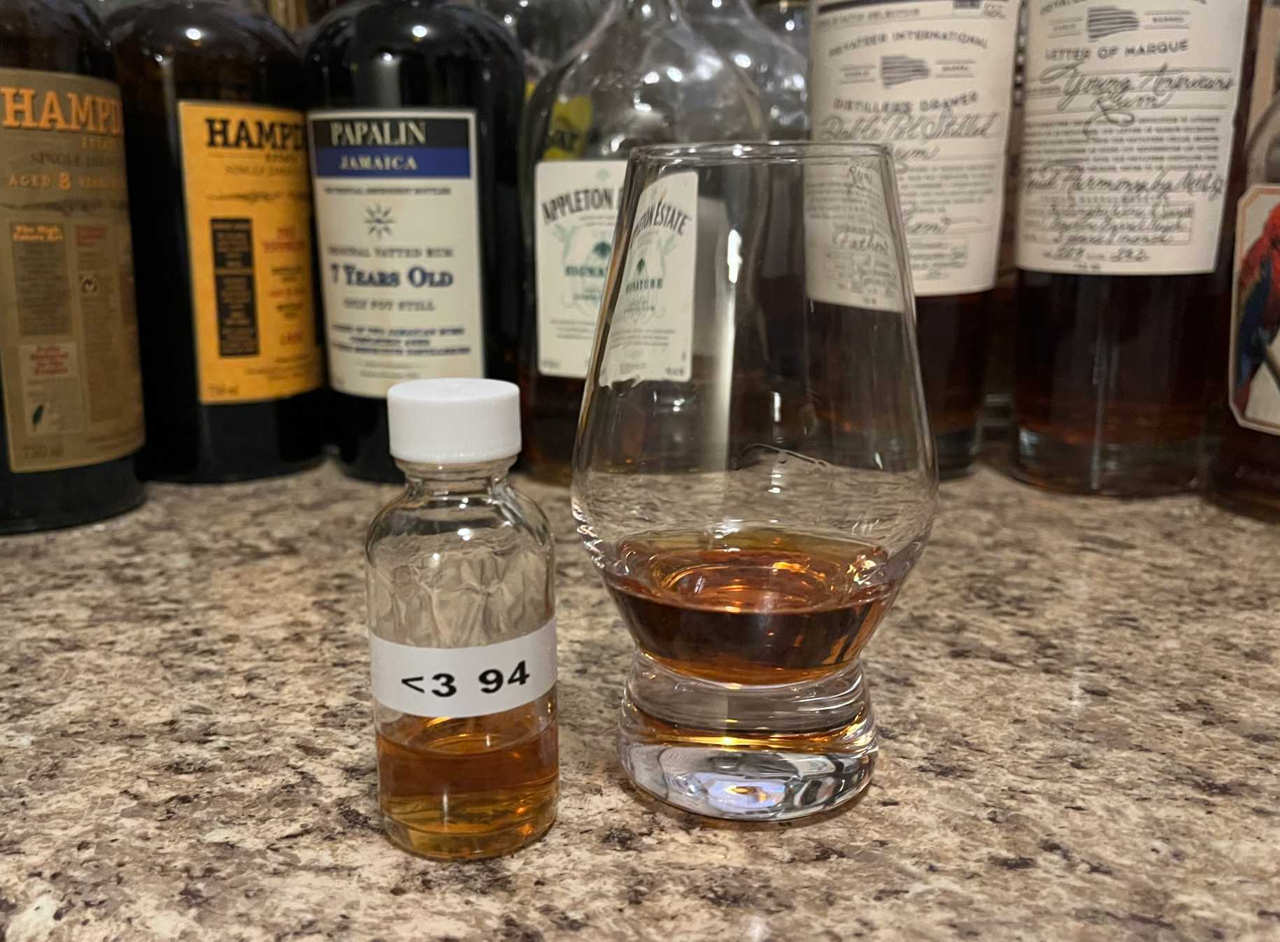 Sample bottle of Appleton Hearts 1994 on a counter next to a glencairn with rum poured in it