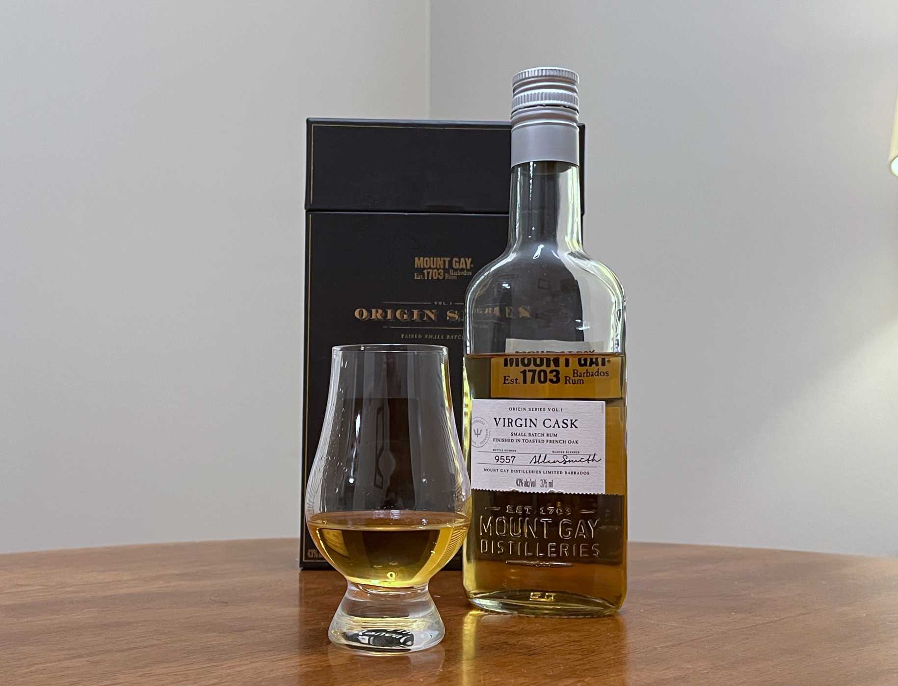 A bottle of Mount Gay Origin Series Virgin Cask next to a glencairn of rum on a kitchen counter