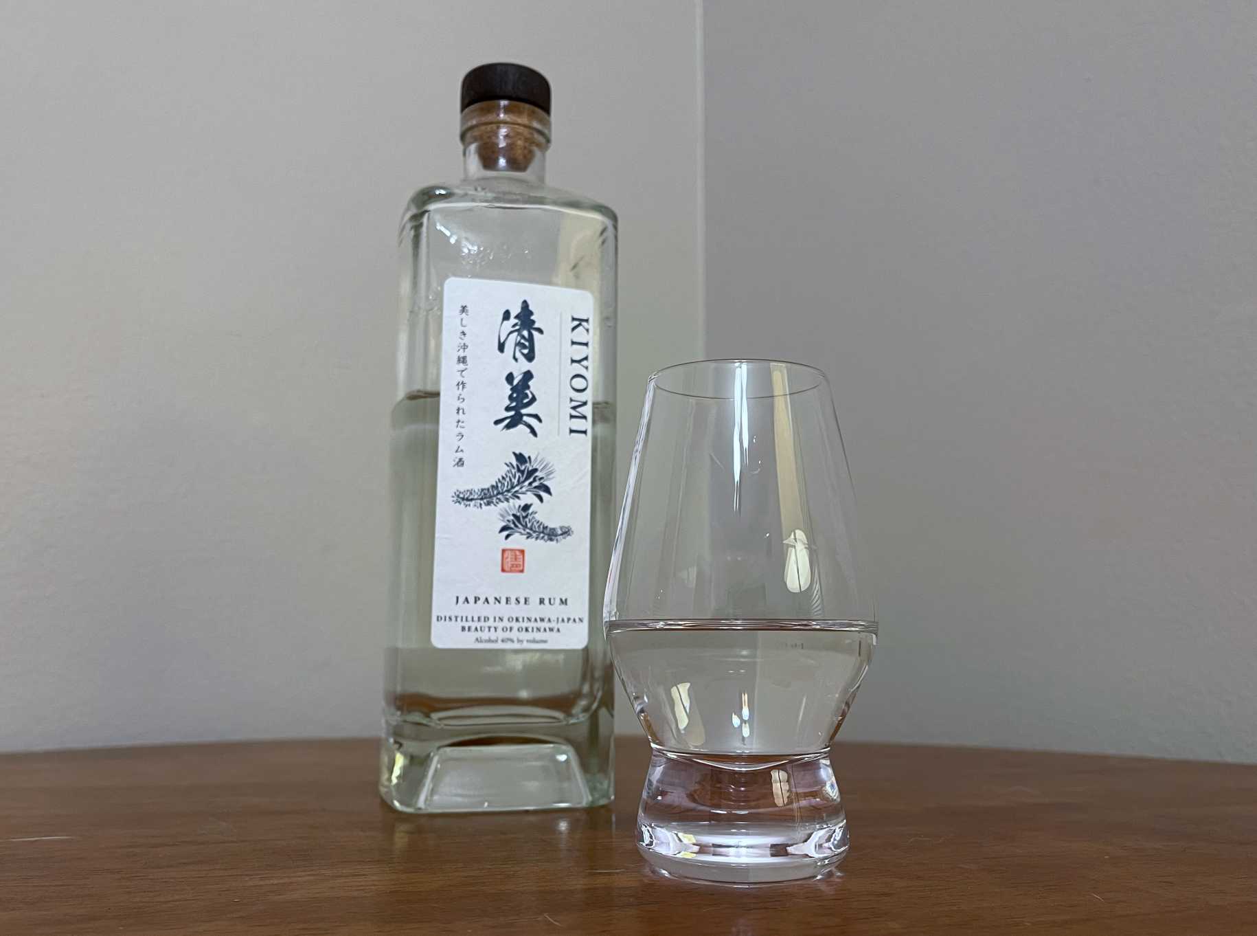 A bottle of Kiyomi Japanese Rum next to a glass of rum